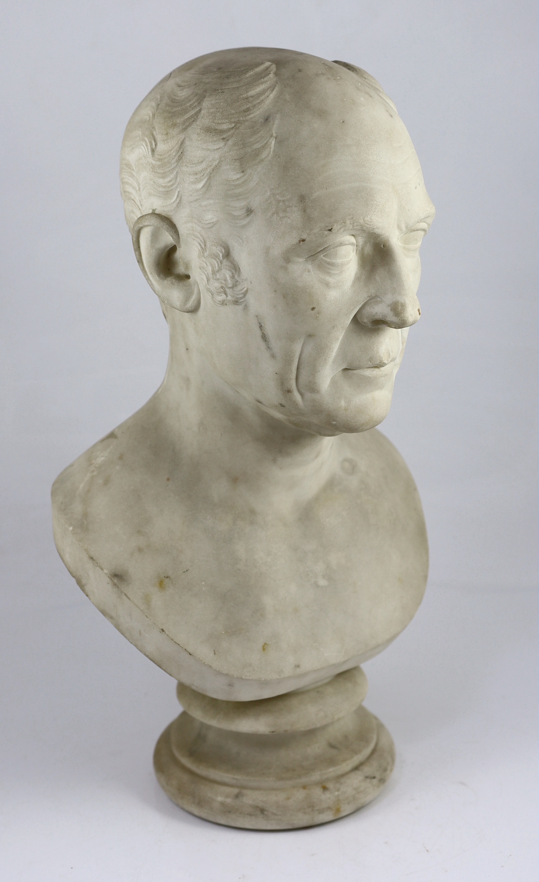 A carved white marble bust of a gentleman, second quarter 19th century, 30cm wide, 54cm high